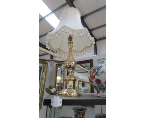 A good brass table lamp with shade.