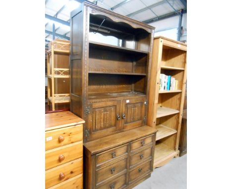 A dark oak drawer based dresser with carved drape panel doors, Height 194cm, width 94.5cm approx.