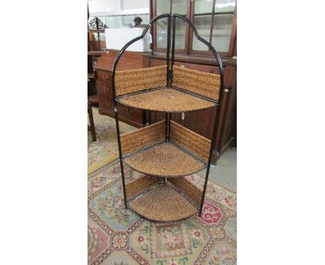 A metal and wicker corner shelf unit.