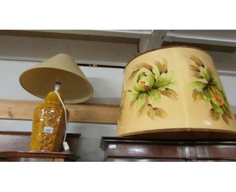 A ceramic table lamp and a large lamp shade.