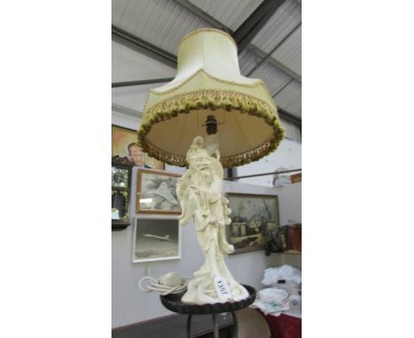 A vintage glazed pottery table lamp in the for of an oriental man complete with shade, (some chips to glaze).