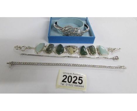 A silver bangle and 3 silver bracelets.