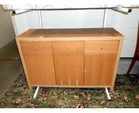 A light oak veneered 3 drawer, 3 door sideboard