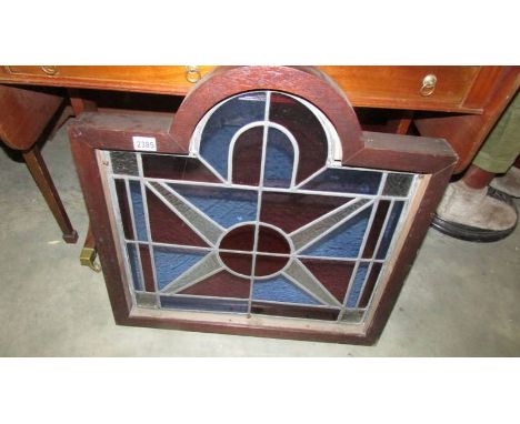 A heavy framed leaded stained glass panel.