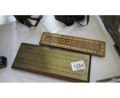 An inlaid Tunbridge ware style cribbage board and a brass cribbage board.