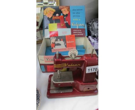 A boxed vintage child's Vulcan sewing machine.
