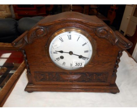 A 1930's oak 8 day mantle clock with enamel dial