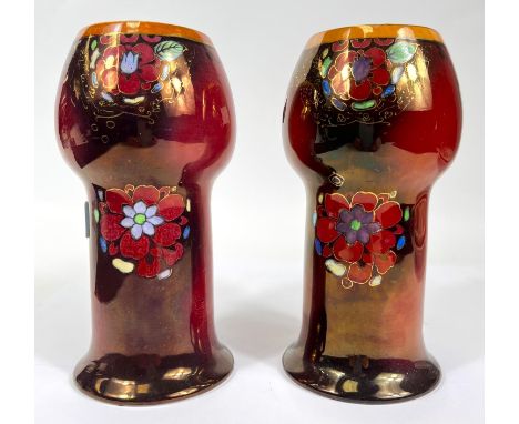 An early 20th century pair of vases by Wilkinson Ltd with bulbous necks, in deep red lustre 