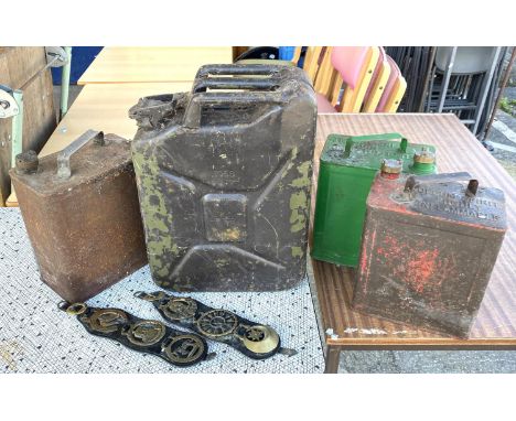 A selection of vintage petrol cans, horse brasses etc