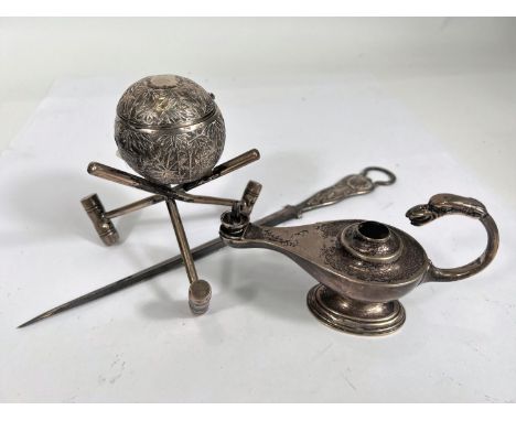 A table lighter in the form of Aladdin's lamp, Birmingham 1912, 3oz; a white metal croquet trophy in the form of a ball and m