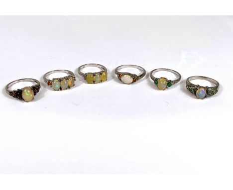 Six silver rings all set with 1 or more opal/opal effect stones, 18.2gm 