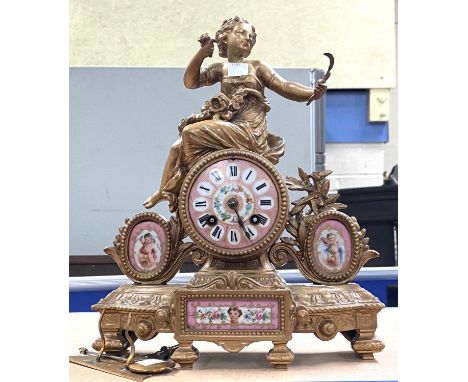 A 19th century gilt metal and pink ground Sevres style porcelain mantle clock surmounted by a woman with sickle with 8 day st