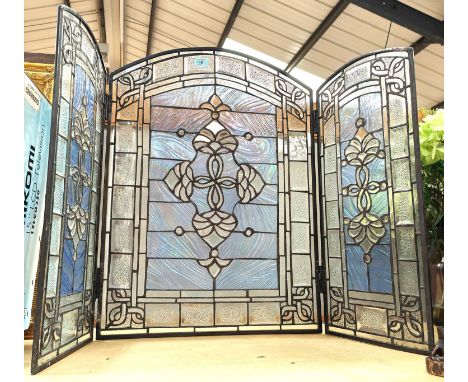 An early 20th century firescreen of 3 coloured and leaded glass panels 