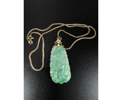 A green jade coloured carved pendant set 4 diamonds, stamped '585 fine', on yellow metal chain stamped '585' No condition iss