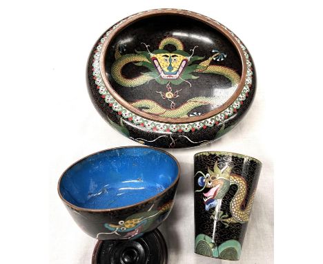 A Chinese cloisonne black ground bowl decorated with dragons and a similar cup.  Bowl 20cm diameter with minor enamel loss, t