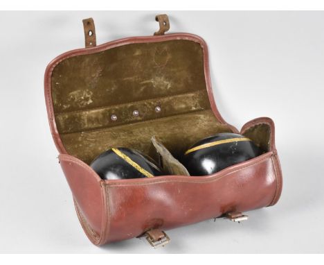 A Pair of Leather Cased Lawn Bowls by Thomas Taylor 