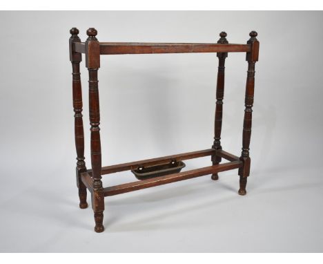A Late Victorian/Edwardian Three Division Walnut Stick Stand with Turned Supports and Small Metal Drip Tray to One Side, 58cm