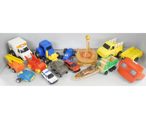 A collection of vintage toys including Bayko, figures and vehicles