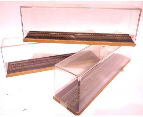 Three locomotive display cases, wood base, perspex lift off top, track on underlay, 35 x 80 x 100 cm. P&amp;P Group 2 (£18+VA