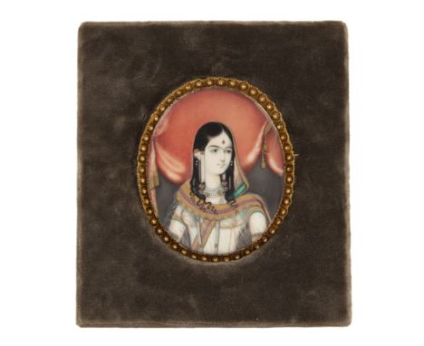 Ivory miniature portrait of a princessIndian, late 19th Centuryin a yellow metal frame/mount, attached to a later velvet Rowl