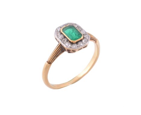 An emerald and diamond cluster ring , circa 1920   An emerald and diamond cluster ring  , circa 1920, the rectangular shaped 