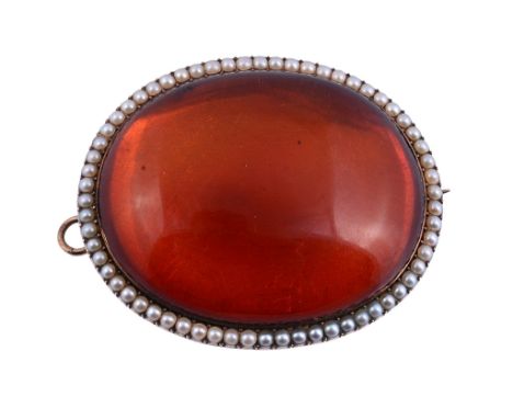 An amber and half pearl brooch, the oval cabochon amber within a border of...   An amber and half pearl brooch,   the oval ca