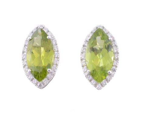 A pair of peridot and diamond earrings, the marquise cut peridot claw set...   A pair of peridot and diamond earrings,   the 