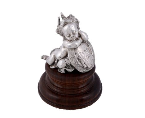 A Victorian silver model of a sleeping cherub, duty and standard marks only   A Victorian silver model of a sleeping cherub, 