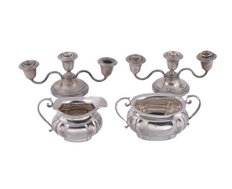 A silver shaped oblong baluster cream jug and sugar basin by Joseph Gloster Ltd   A silver shaped oblong baluster cream jug a