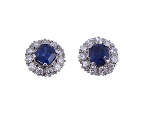 A pair of sapphire and diamond ear studs, the central square cut sapphire...   A pair of sapphire and diamond ear studs,   th