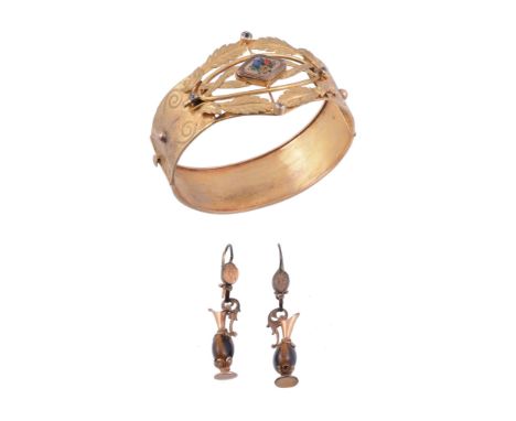 A late 19th century hinged gold bangle, circa 1890   A late 19th century hinged gold bangle,   circa 1890, with engraved foli