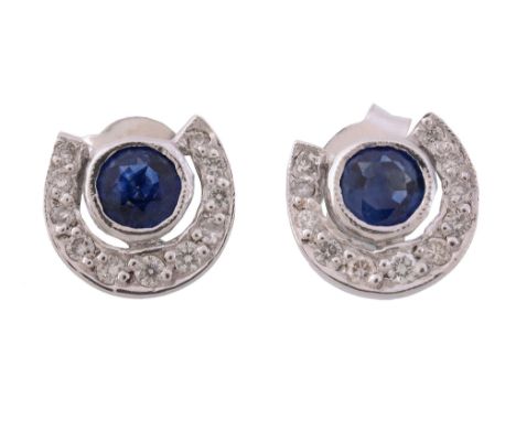 A pair of sapphire and diamond ear studs, the circular cut sapphire within a...   A pair of sapphire and diamond ear studs,  