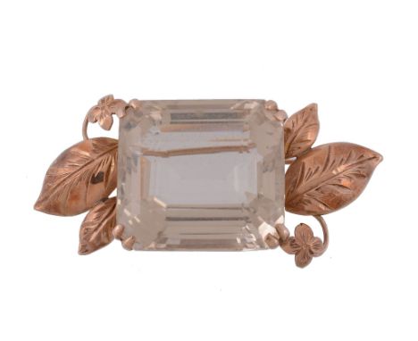 A citrine brooch, the rectangular step cut citrine in a claw setting   A citrine brooch,   the rectangular step cut citrine i