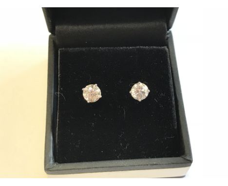 Pair of 14 carat white gold & diamond stud earrings of 1.5 carats approx.