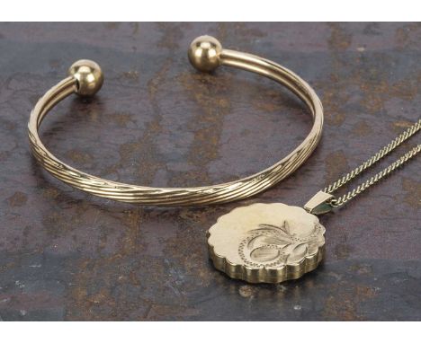 A 9ct gold torque child's bangle, with sphere terminals, 5.5cm x 4.5cm, 3.9g together with a rolled gold circular locket and 