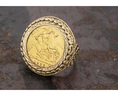 An Elizabeth II half sovereign 9ct gold dress ring, half sovereign dated 1982 within a heart and pierced ornate mount, ring s