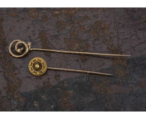 Two yellow metal stick pins, one of knot design, 7.5cm, the other of target design, 5cm