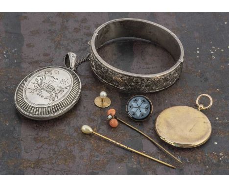 A Victorian silver engraved oval locket, decorated in the aesthetic taste with initials engraved to the reverse, London 1879 