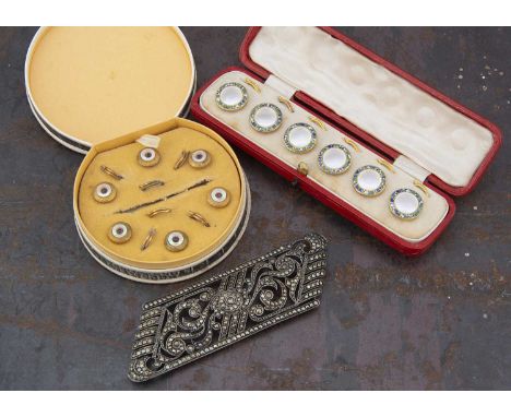 An Art Deco cased set of dress studs,  the gild metal surrounds with concave centres, surrounded by mottled blue green and wh