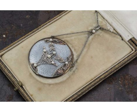 An Edwardian silver and enamel, diamond and pearl pendant, set with diamonds and seed pearls, the disc shaped locket with flo