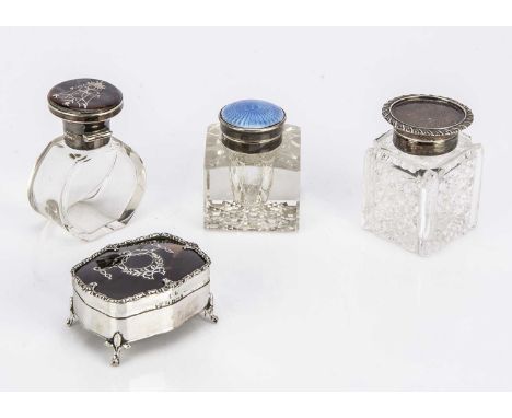An Edwardian silver and tortoiseshell trinket box and three glass and silver mounted bottles, the box 6cm wide, with a silver