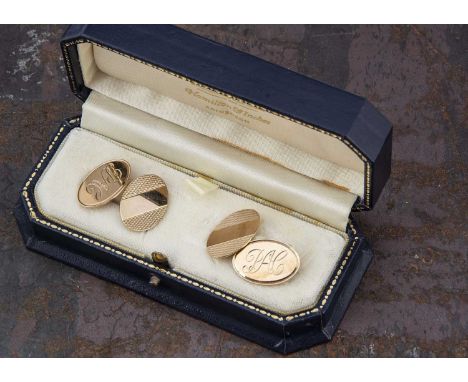 A cased pair of 9ct gold oval chain linked cufflinks, with engine decoration and initials PAC 1.9 cm by 1.4 cm, 7.6g