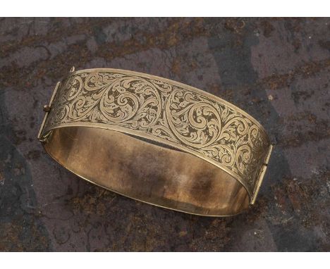 An Albion 9ct and metal core bangle, scroll engraved top section, 6 cm by 5 cm, 24g