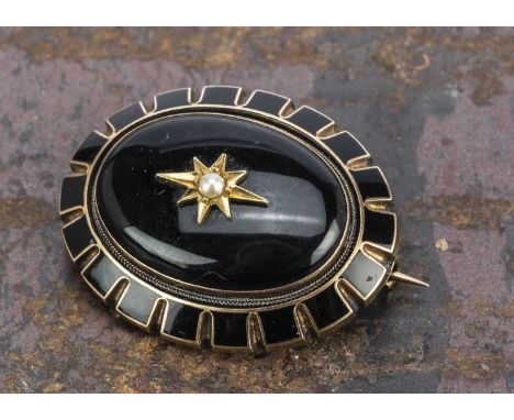 A 19th century oval gold enamel and seed pearl brooch, with domed centre with gypsy setting, surrounded by an enamel surround