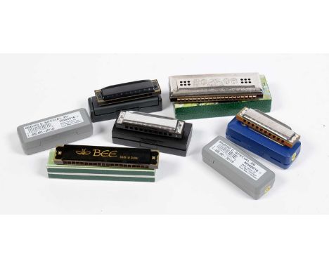 Seven harmonicas, including: a Hohner Echo Harp, boxed, a Hohner pro harp in G, two Hohner Special Marine Band harmonicas in 