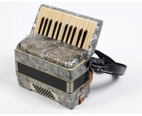 A Worldmaster 32 bass piano accordion, with grey pearloid finish, hard case.