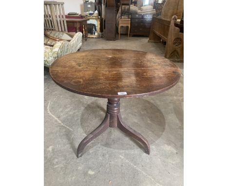 A 19th century oak snap-top table on tripod support. 32' diam.