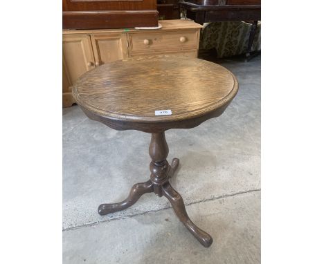 A mahogany tripod table with shaped snap top. 27' diam.