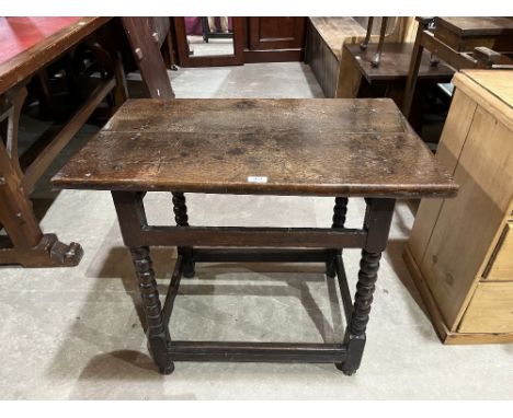 A 17th century joined oak side table on bobbin turned legs and channel moulded perimeter stretchers. 32' wide. Drawer lacking