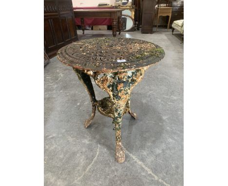 A cast iron garden table on figural moulded cabriole legs. 23' diam.